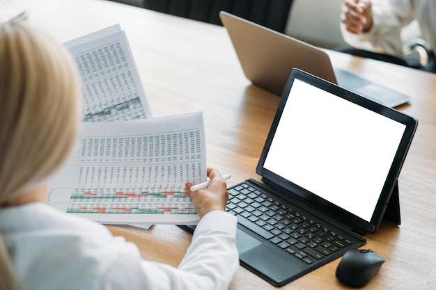 A close-up shot of a person using a tax preparation software on a laptop. The screen displays tax forms and financial calculations, with a focus on the updated tax brackets.