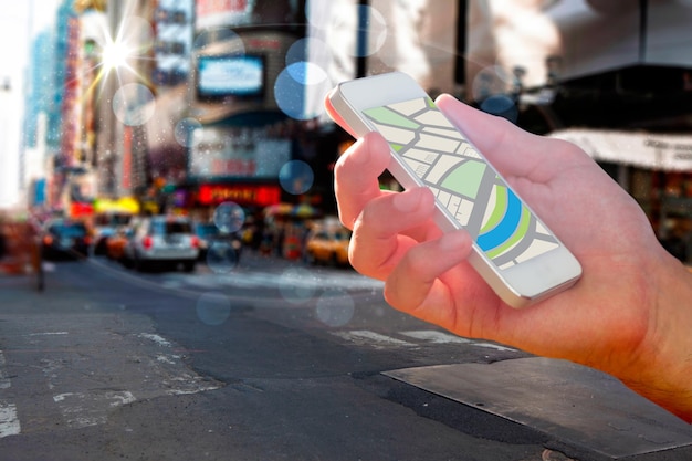 A close-up of a smartphone showing the Desenrola Brasil app interface, with options for debt negotiation and discounts highlighted, against a busy urban backdrop of Brazil.