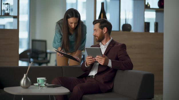 A professional financial advisor reviewing documents with a client in a modern office setting. The atmosphere is calm and focused, symbolizing trust and expertise in financial planning.
