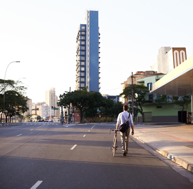 A sunny, pedestrian-friendly street in Fortaleza, Brazil, featuring wide sidewalks, shaded bike lanes, and accessible crosswalks. The image shows people walking, cycling, and enjoying the urban environment.