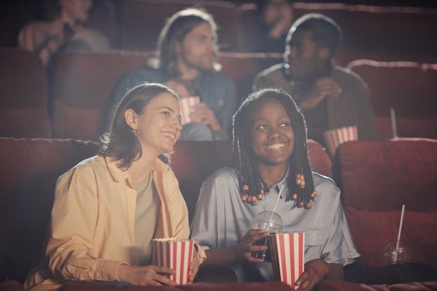 A diverse group of people watching a film in a movie theater, representing the varied audience that benefits from the Marco Legal's promotion of national content.