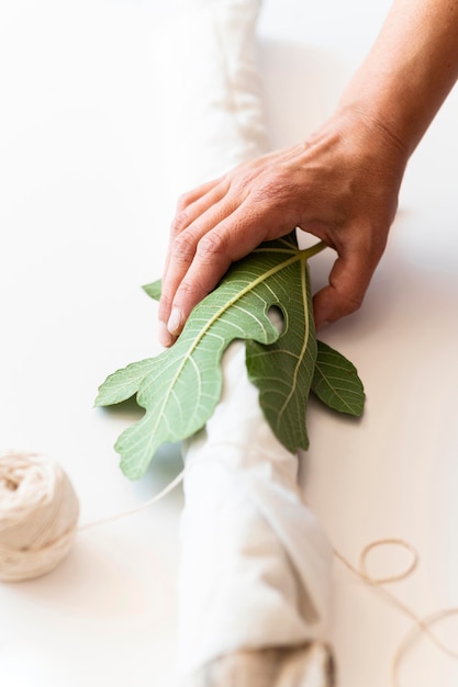 A close-up shot of a Brazilian fashion designer working on a sustainable garment, using natural fabrics and traditional techniques, showcasing the fusion of art and environmental consciousness.