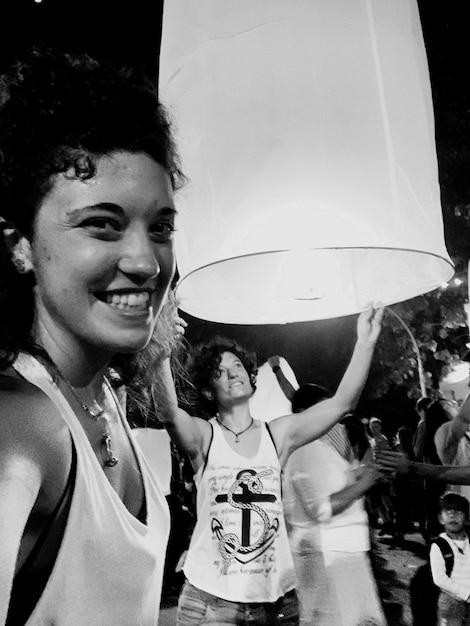 A powerful black and white photograph of an indigenous leader in Brazil, protesting for land rights. His face shows determination and resilience. In the background, a crowd of indigenous people hold signs and banners. The image should convey a sense of struggle and resistance.