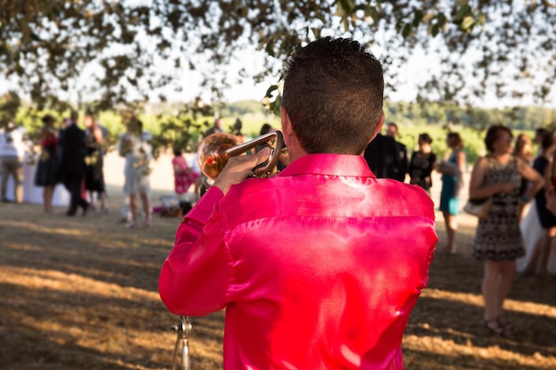 A wide shot of a Festa Junina celebration in the countryside of Brazil, with people dressed in traditional checkered shirts and straw hats dancing around a bonfire under a sky filled with colorful paper lanterns.