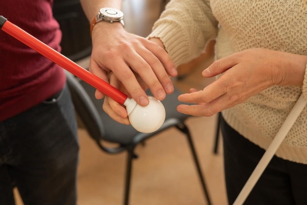 A close-up shot of a Boccia ball being released from a ramp by a player during a Paralympic competition. The focus is on the ball's trajectory and the player's focused expression.