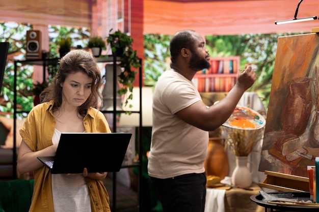 Artists collaborating in a studio, showcasing the importance of networking and community in the Brazilian art scene.