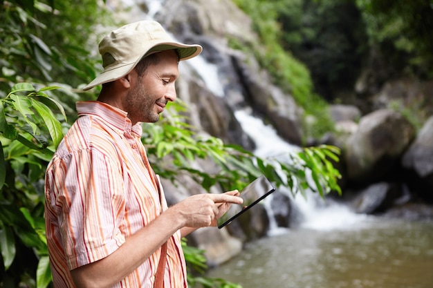 A Brazilian scientist collecting water samples in the Amazon rainforest to study the effects of climate change on the ecosystem. The image should highlight the importance of fieldwork and environmental research.