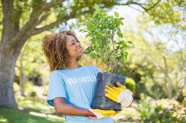 A Brazilian politician is actively participating in a community project, such as planting trees or helping with a local clean-up initiative. The image shows their dedication to improving the community.