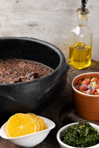 A close-up shot of a traditional feijoada dish being prepared with colorful ingredients in a rustic Brazilian kitchen.