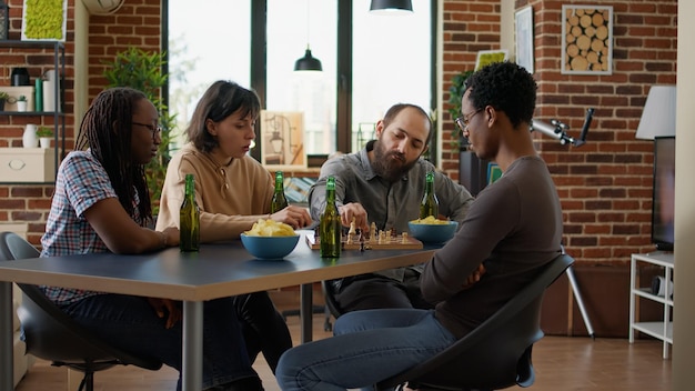 A group of diverse professionals collaborating around a table, with [Nome de Personalidade Brasileira] facilitating the discussion. The atmosphere is energetic and collaborative, with laptops and brainstorming notes scattered on the table. The focus is on teamwork and problem-solving.
