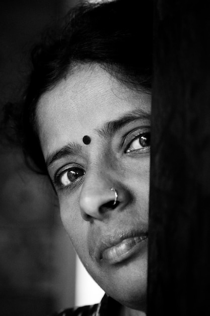 A close-up, black and white portrait of [Nome de Personalidade Brasileira] with a determined expression, showcasing their resilience.